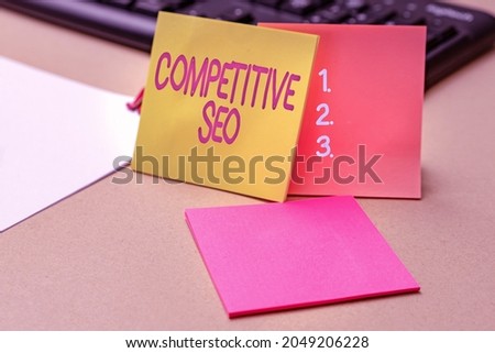 Text sign showing Competitive Seo. Business overview the process of evaluating how the top rankings fare Multiple Assorted Collection Office Stationery Photo Placed Over Table