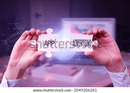 Text sign showing App Advertising. Business concept developers get paid to serve advertisements in mobile app Business Woman Holding Jigsaw Puzzle Piece Unlocking New Futuristic Tech.