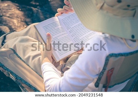 Women tourists read book in the holiday in quiet nature, Concept reading a book.