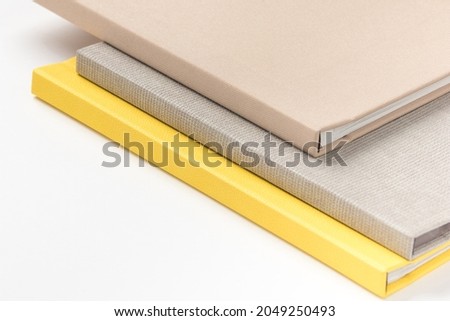 Pile multicolor hardcover books on white background