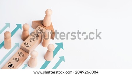 The leader, wooden figure leading the team with business icon on wood block with heading arrows on white background with copy space. Business strategy with growth success process, leadership concept. Royalty-Free Stock Photo #2049266084