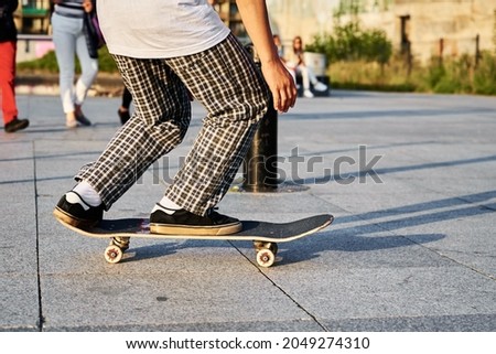 Skateboarder ride on skateboard at city street. Scater practice skate board tricks at skatepark. Teenager extreme sport