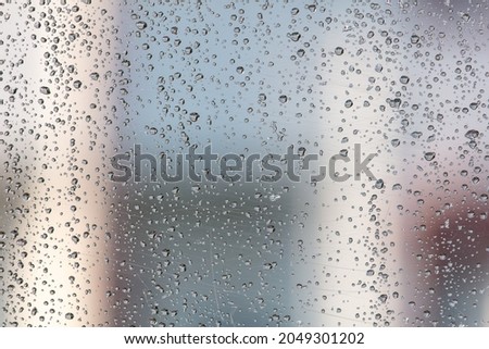 Drops on glass from rain as an abstract background. Close-up