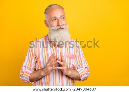 Photo of intelligent pensioner man hold fingers look empty space wear striped shirt isolated yellow color background
