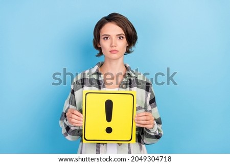 Photo of serious millennial brunette lady hold sign wear plaid shirt isolated on blue color background