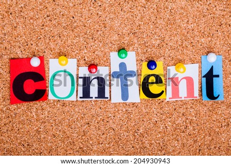 The word content in cut out magazine letters pinned to a cork notice board
