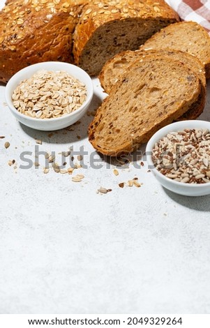fresh bread with oatmeal and seeds, cut into slices, vertical top view
