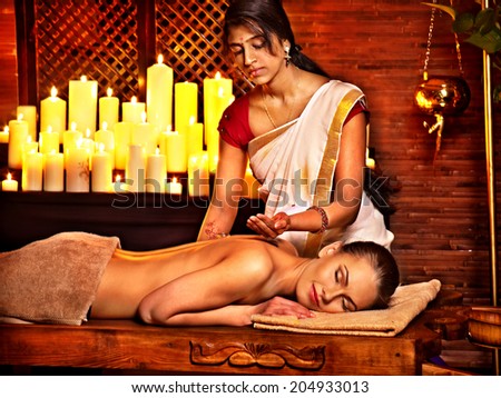 Young woman having oil Ayurveda spa treatment.