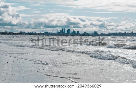 View of Tallinn from Pirita across the sea. Cold north sea, waves, city in the distance. cold shade.