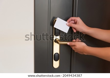 Opening a hotel room door with a magnetic key Royalty-Free Stock Photo #2049434387