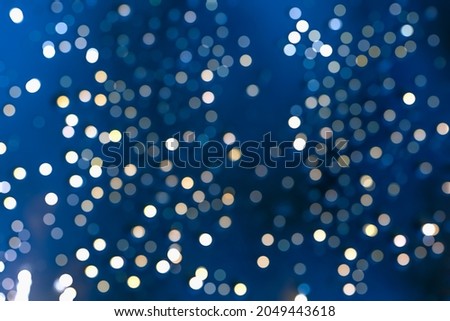 TWINKLY BOKEH STARS AT NIGHT DARK BLUE SKY, MAGICAL CHRISTMAS BACKGROUND Royalty-Free Stock Photo #2049443618