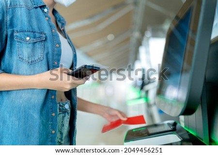 asian female traveller casual cloth hand show smartphone scan online check in for flight boarding departure at airport terminal,travel after covid lockdown is over concept Royalty-Free Stock Photo #2049456251