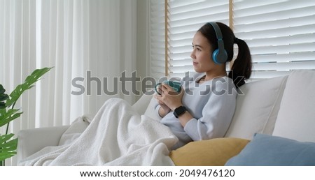 Asia teen girl people enjoy coffee in break time self relax happy joy with good song in online radio app sitting rest sleep at cozy sofa. Youth fun hobby indoor lazy zen life smile napping at home.