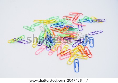 The Colorful Paper Clips on a White Background.