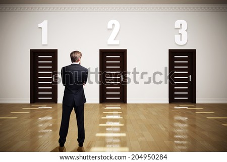businessman has to choose between 3 options Royalty-Free Stock Photo #204950284