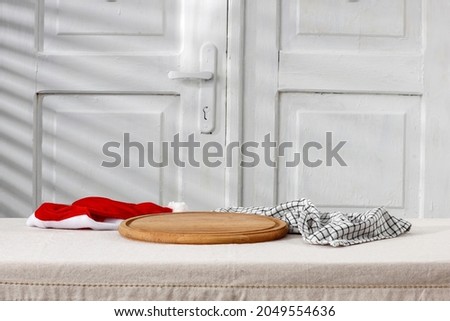 White wooden Christmas board on a white background of wooden doors with shadow and blank 