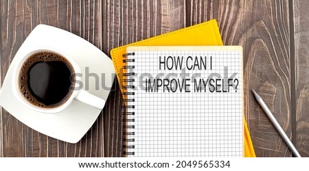 How can I improve myself text on the notebook with coffee on the wooden background