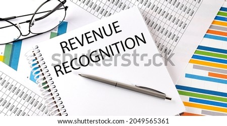 REVENUE RECOGNITION , pen and glasses on the chart, business