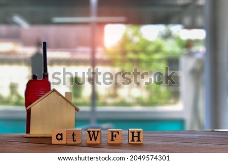 Work at home, the words of cubic letters on a wooden surface, WFH, the effect of COVID 19 concept