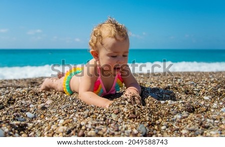 Child girl at the sea. Selective focus. Baby.