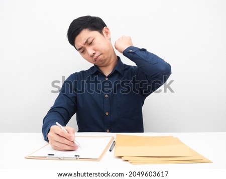Man writing and working wtih document at the table feeling tried white background
