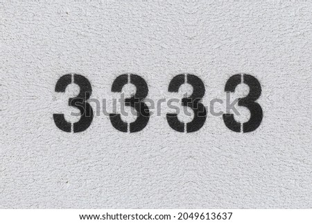Black Number 3333 on the white wall. Spray paint. Number three thousand three hundred thirty three.