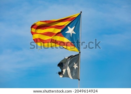 Flag and national symbol of the pro-independence Catalan people, known as estelada, waving in the town of Ginestar, province of Tarragona