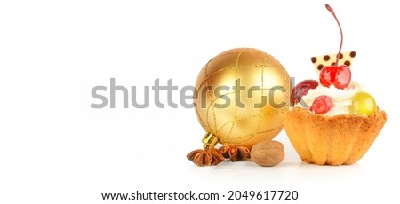 Christmas composition: Christmas ball, cake and aromatic spices isolated on a white background. There is free space for text. Wide photo.
