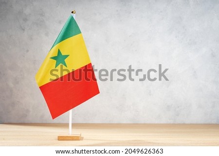Senegal table flag on white textured wall. Copy space for text, designs or drawings