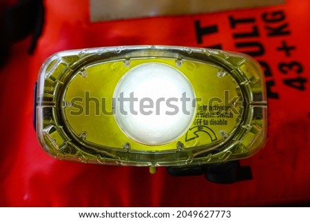 close up emergency lighting on life jacket, activates by water. Royalty-Free Stock Photo #2049627773