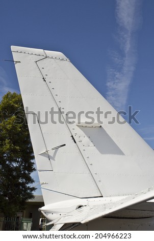 A tailplane, also known as horizontal stabilizer, is a small lifting surface located on the tail   behind the main lifting surfaces of a fixed-wing aircraft. Royalty-Free Stock Photo #204966223