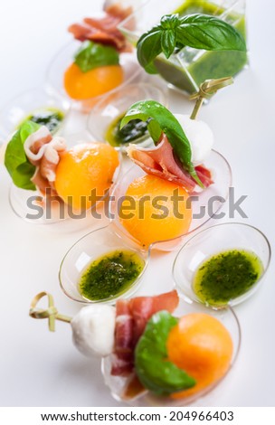 Appetizer with melon,mozzarella and prosciutto on skewers