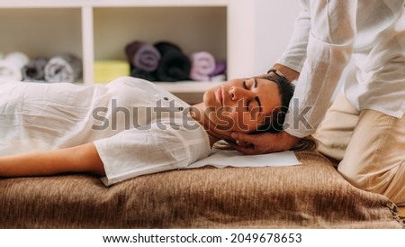 Therapist stretching woman’s neck. Shiatsu massage. Royalty-Free Stock Photo #2049678653