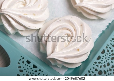 Homemade marshmallows of various shapes and colors are laid out on trays. Stabilization of Zephyr before packaging. Royalty-Free Stock Photo #2049687602