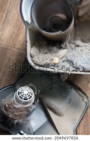 Dust container in a vacuum cleaner with a lot of dust. Dust is the cause of allergies and feeling unwell Royalty-Free Stock Photo #2049697826