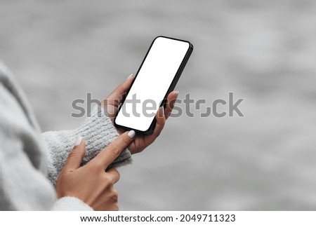 Woman use the iPhone 13 pro with white screen Royalty-Free Stock Photo #2049711323