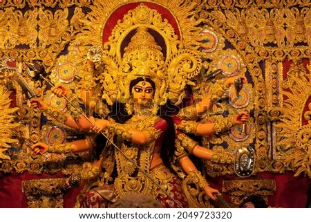 Goddess Durga idol decorated at puja pandal in Kolkata, West Bengal, India. Durga Puja is biggest religious festival of Hinduism and is now celebrated worldwide. Royalty-Free Stock Photo #2049723320