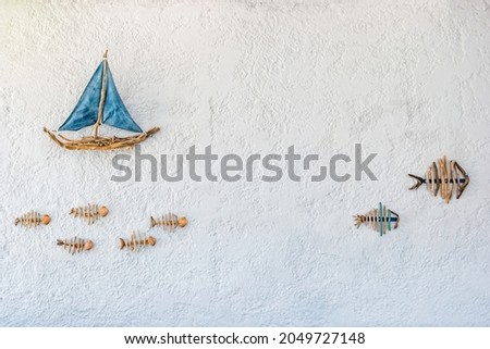 Boat and fish - picture on the wall of a restaurant on the on the Halki Island near Rhodes, Greece.