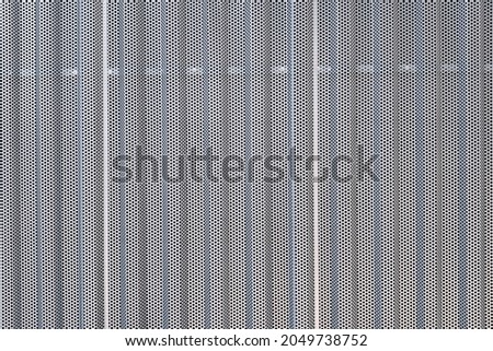 Gray background with perforated metal texture.