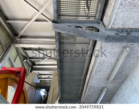 Industrial exposed ceiling with timber boards, steel beams and exposed wiring. Textured background graphic asset.