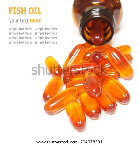 Fish oil capsules pouring out of the bottle isolated on white background