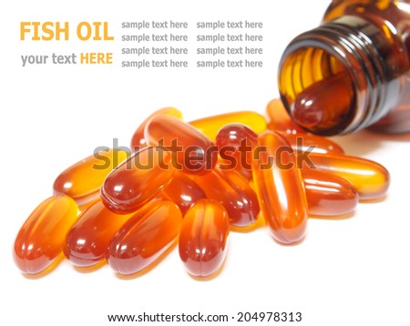 Fish oil capsules pouring out of the bottle isolated on white background