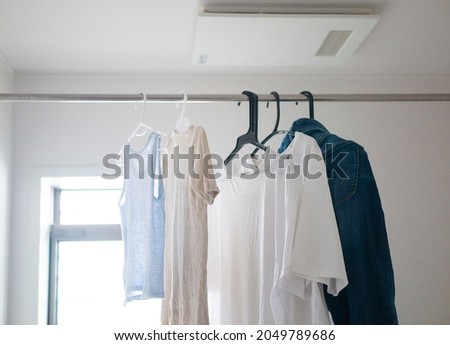 Drying laundry in bathroom by dehumidifier Royalty-Free Stock Photo #2049789686