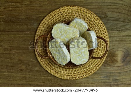 Slices of Tempe in a rattan basket, Tempe is Made from Fermented Soybeans