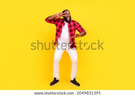 Full size photo of cheerful excited cool happy afro american man dance v-signs isolated on yellow color background