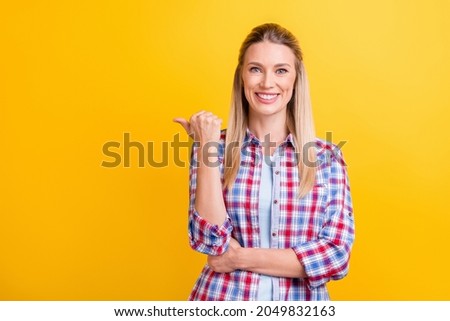Photo of funky blond hr lady point empty space wear blue shirt isolated on yellow color background