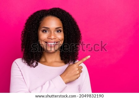 Photo of funky young brunette lady point empty space wear pink sweater isolated on magenta color background