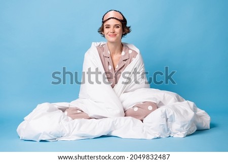 Full body photo of happy cute girl wrapped sit blanket bedroom comfort isolated on pastel blue color background Royalty-Free Stock Photo #2049832487