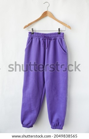 training jogger pants color purple front view on the hanger Royalty-Free Stock Photo #2049838565