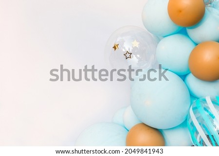 White background with a place for text decorated with blue and yellow balloons.